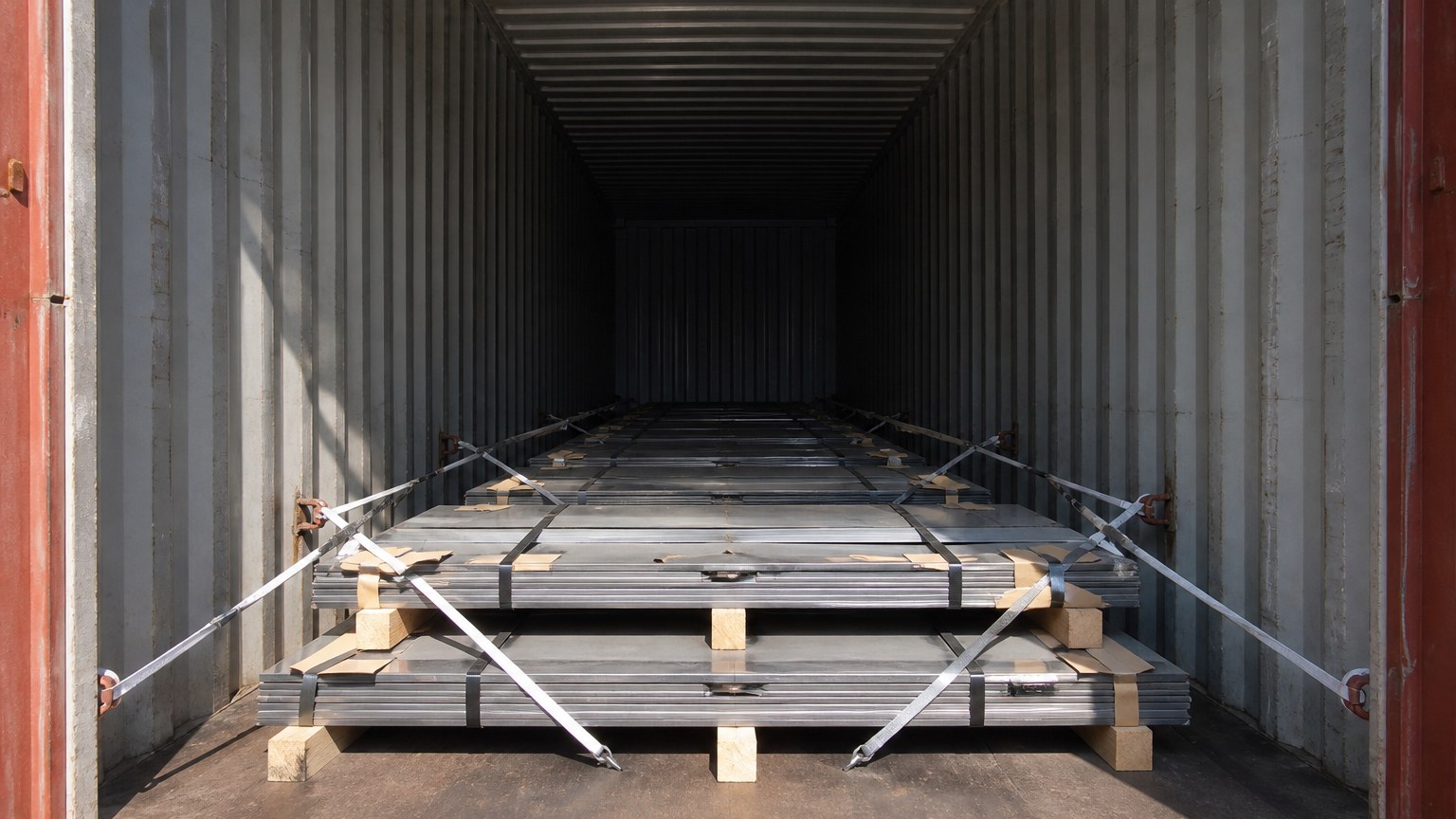 steel import process - stainless steel plate bundles being lashed and loaded into a container at an export warehouse