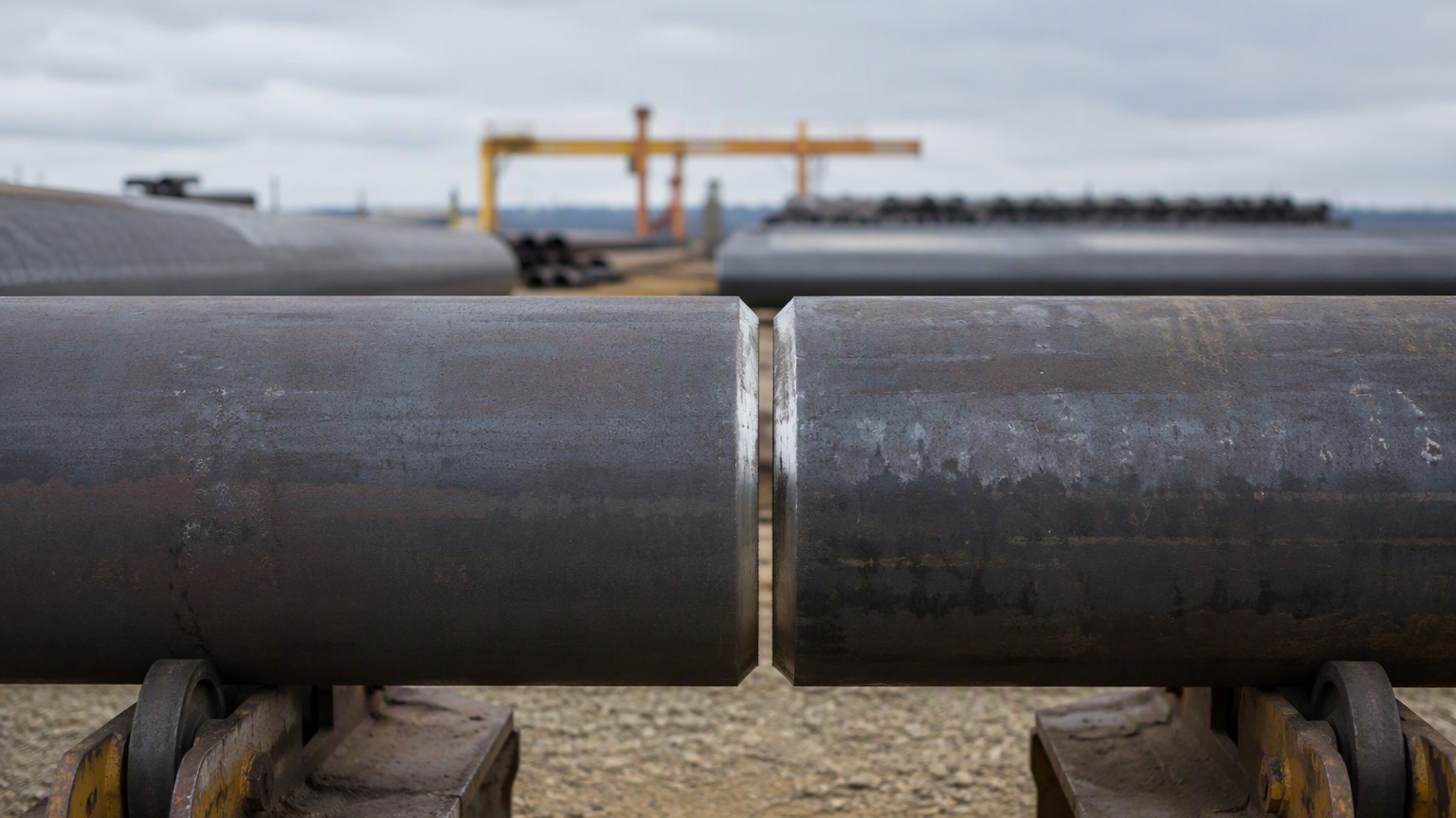 pipe end finish - beveled ends of two large seamless carbon steel pipes aligned for welding in a pipeline yard